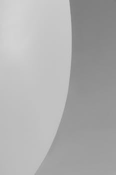 Simple abstract composition featuring a gray and white minimalist design.